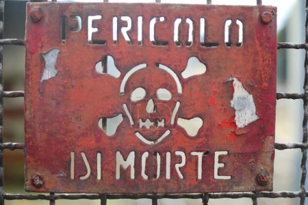 eisernes Schild mit dem Schriftzug in italienischer Sprache Pericolo di Morte, was Todesgefahr bedeutet, wenn man die Schutzbarriere passiert