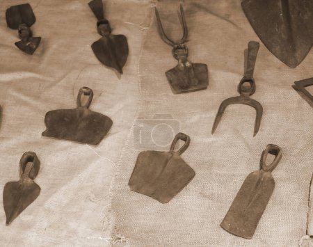 Téléchargez les photos : Vieux outils agricoles rouillés utilisés il y a longtemps par les agriculteurs avec un effet vieilli de couleur sépia - en image libre de droit