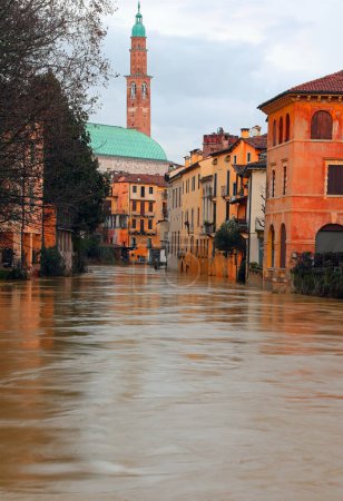 High level of the water of River called RETRONE in Vicenza City during flood and the monument Basilica Palladina in background