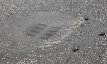 Photo for Clogged cast iron drain which does not allow the water to flow out and causes flooding - Royalty Free Image