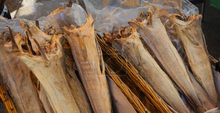 Dried headless stockfish is a popular delicacy for sale at the fish market