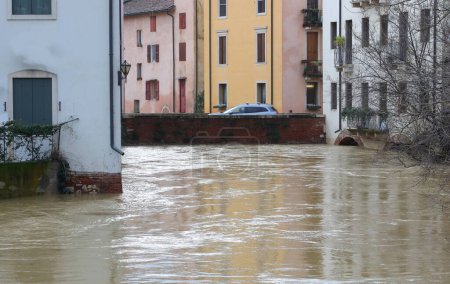 Arch of a bridge submerged by the Retrone River in Vicenza in Italy during a flood caused by climate change