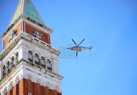 Photo for Venice, VE, Italy - February 13, 2024: Bell tower of Saint Mark and Italian Police helicopter in the sky - Royalty Free Image