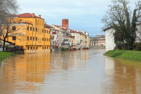 Photo for Houses on the banks of the Bacchiglione River at risk of flooding in the city of VICENZA in Northern Italy after rains - Royalty Free Image