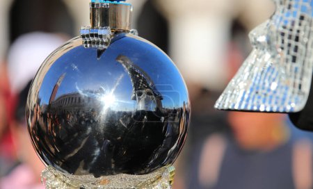 Spherical mirror reflecting Venetian landmarks and a mask with customizable text during Carnival