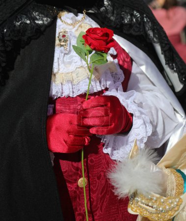Aristokratischer Geliebter mit roten Handschuhen reicht seiner Geliebten eine rote Rose