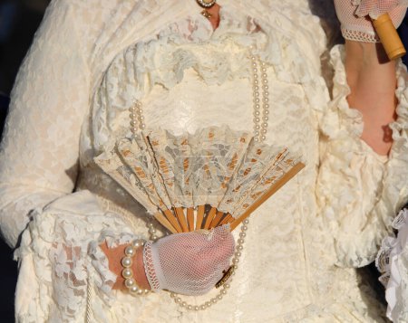 Elegancia veneciana Una dama con un ventilador plegable en un baile de máscaras