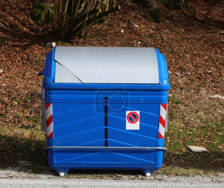 large blue metallic bin for the collection of solid urban waste and no parking