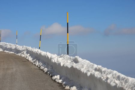 piquets de neige ont été placés le long du bord de la route pour marquer le bord de l'asphalte