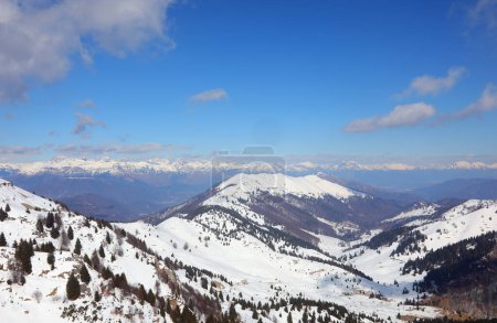 snowy panorama of the Italian Alps in Northern Italy in winter without people and blue sky