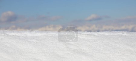 Heap of fresh white snow just fallen in the mountains and the mountains in the background out of focus