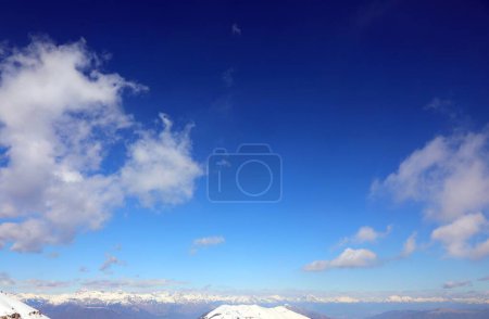 Blue sky with very intense and vibrant color and snow-capped mountains in winter