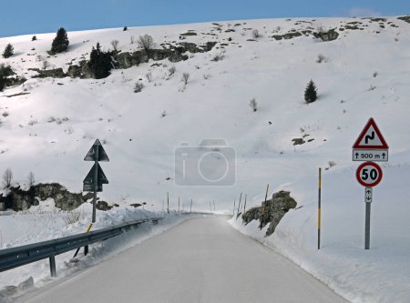 dangerous very slippery mountain road with ice sheet after snowfall