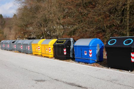 Numerosos contenedores de residuos y materiales reciclables en la carretera en una ciudad sin personas