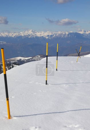 Black and yellow snow markers also called snow stakes on the road
