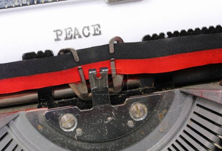 Typewritten peace in black ink on paper with an old typewriter