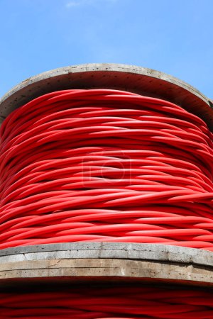 Underside view of a red high-voltage electrical power cable spool