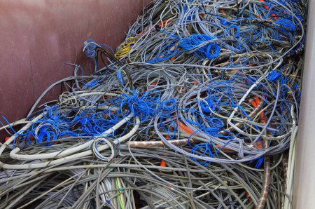 Photo for Discarded electrical wires pile up in the recyclable material collection container - Royalty Free Image