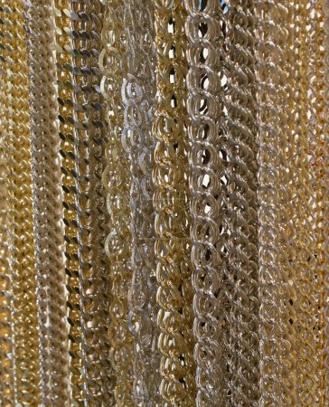 background of many golden silver metal chains ideal as a backdrop for jewelery shops