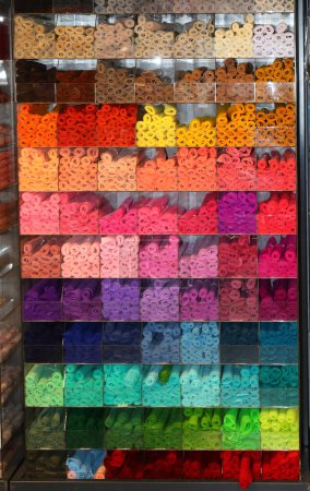 many colorful rolls of felt fabric for sale on shelf in hobby supplies store