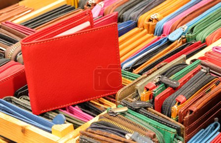Red wallet and other leather zip wallets created by hand by the skilled craftsman for sale in the leather goods shop