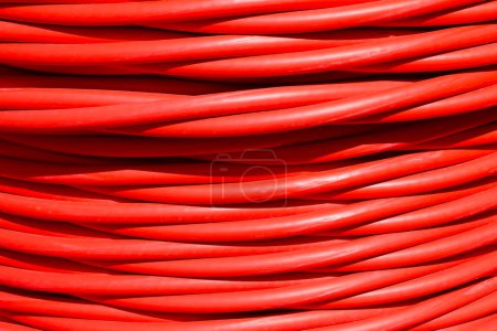 background of red cable used for high-voltage power transmission from a power plant to substations