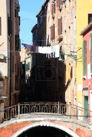 glimpse of Italian houses with the bridge and clothes hanging out to dry in the sun