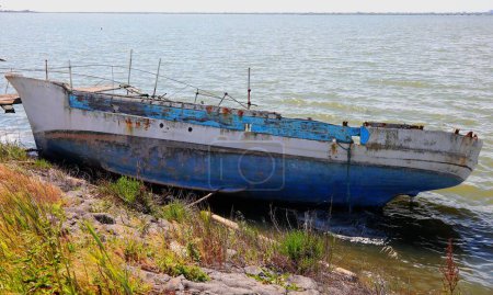 Wooden boat shipwreck washed ashore after sea crossing