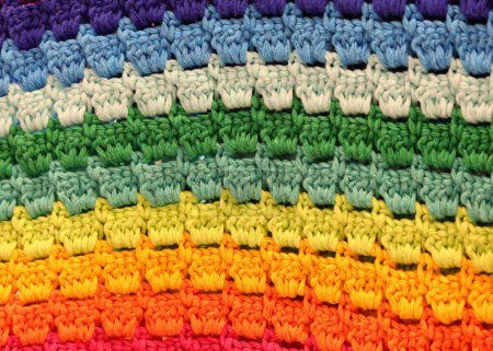 embroidery of cotton threads forming a rainbow of many colors a symbol of unity in diversity
