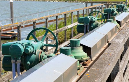 series of numerous sluice gate valves for water regulation in the flood control basin.