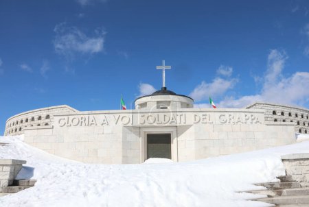 Photo for Pieve, TV,WAr  Italy - March 13, 2024: Military Memorial ossuary and text that means GLORY TO SOLDIERS OF GRAPPA MOUNT with snow - Royalty Free Image