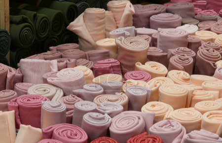 colorful rolls of felt fabric for the creation of clothes and hobby objects on sale in the wholesale haberdashery shop