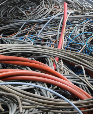 Old electrical wires in landfill for recycling copper and polluting plastic