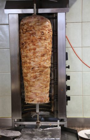 very big Kebab skewer with meat that rotates on itself with a movement effect in the eating area