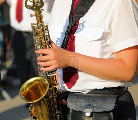 female saxophonist playing in a marching band during a performance
