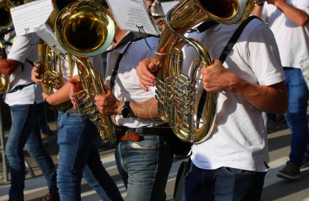 Photo for French horn players in a marching band performing on the road - Royalty Free Image