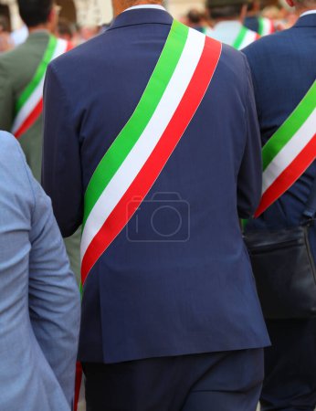 Italian mayor wearing the national tricolor green white and red sash during meeting