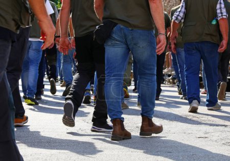 many men walking down the street with their jeans photographed behind them