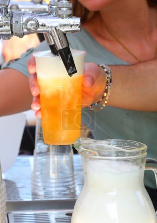 Busy bartender pouring a glass of fresh beer during party