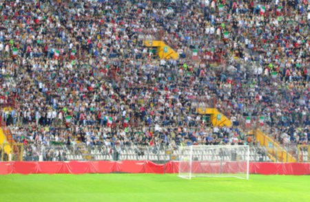 Intentionally blurred audience during crowded stadium stands as a backdrop for entertainment