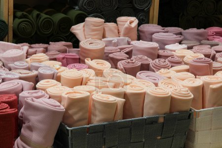 colorful rolls of felt fabric for the creation of clothes and hobby objects on sale in wholesale haberdashery shop