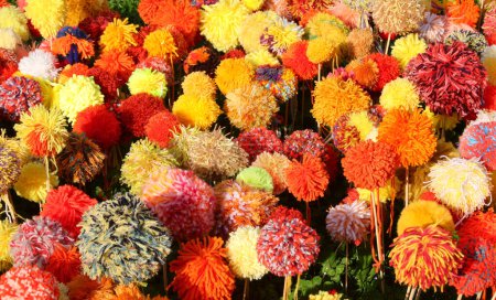 flowers made with numerous soft pompoms made with colorful soft wool threads