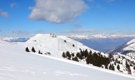Snowy mountain panorama with fresh snow in winter with clear blue sky a