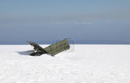 canon vert de la Première Guerre mondiale enterré sous beaucoup de neige blanche fraîche en hiver sur le sommet de la montagne