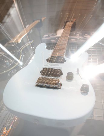 White electric guitar with a strange zoom optical effect and lights created by moving the camera lens