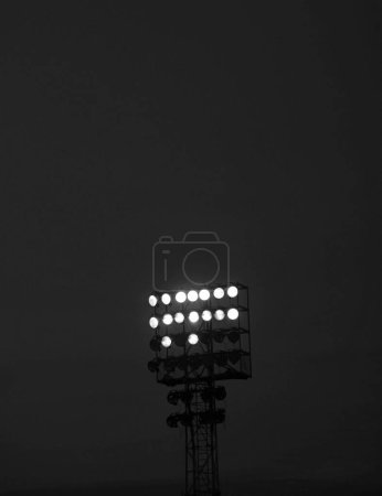 Powerful illuminated stadium lights during a black and white night event
