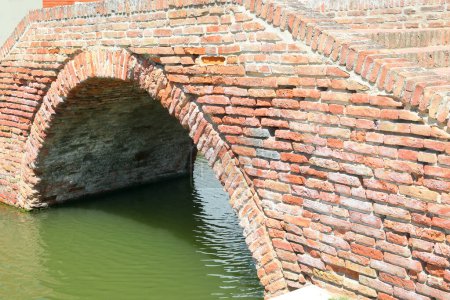 Photo for Old brick arch bridge over a canal with no boats - Royalty Free Image