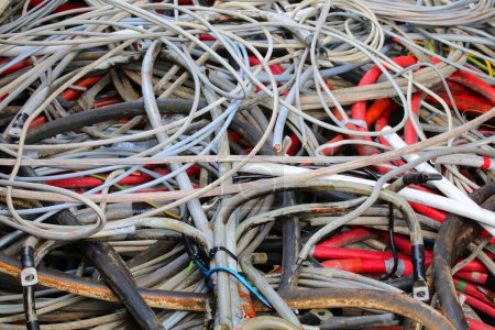 numerous discarded electrical wires once used to transmit electricity and now destined for recycling to reclaim the valuable copper within