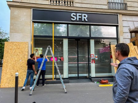 Photo for Paris, France, Workers Protecting Store Window, Before Anti-Government, Anti-Macron, Anti-Retirement Law Reform Demonstrations, May Day - Royalty Free Image
