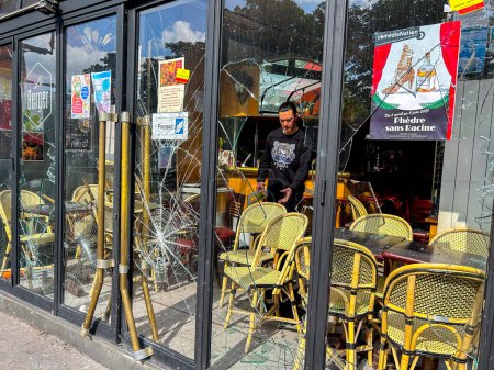 Photo for Paris, France, Man Cleaning up, Damage to CIty After Anti-Government, Anti-Macron, Anti-Retirement Law Reform Demonstrations, French Cafe Windows Broken - Royalty Free Image